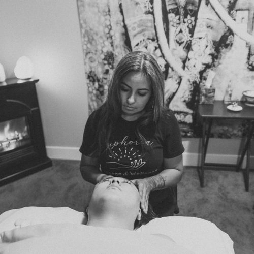 Evita giving a massage by the fireplace