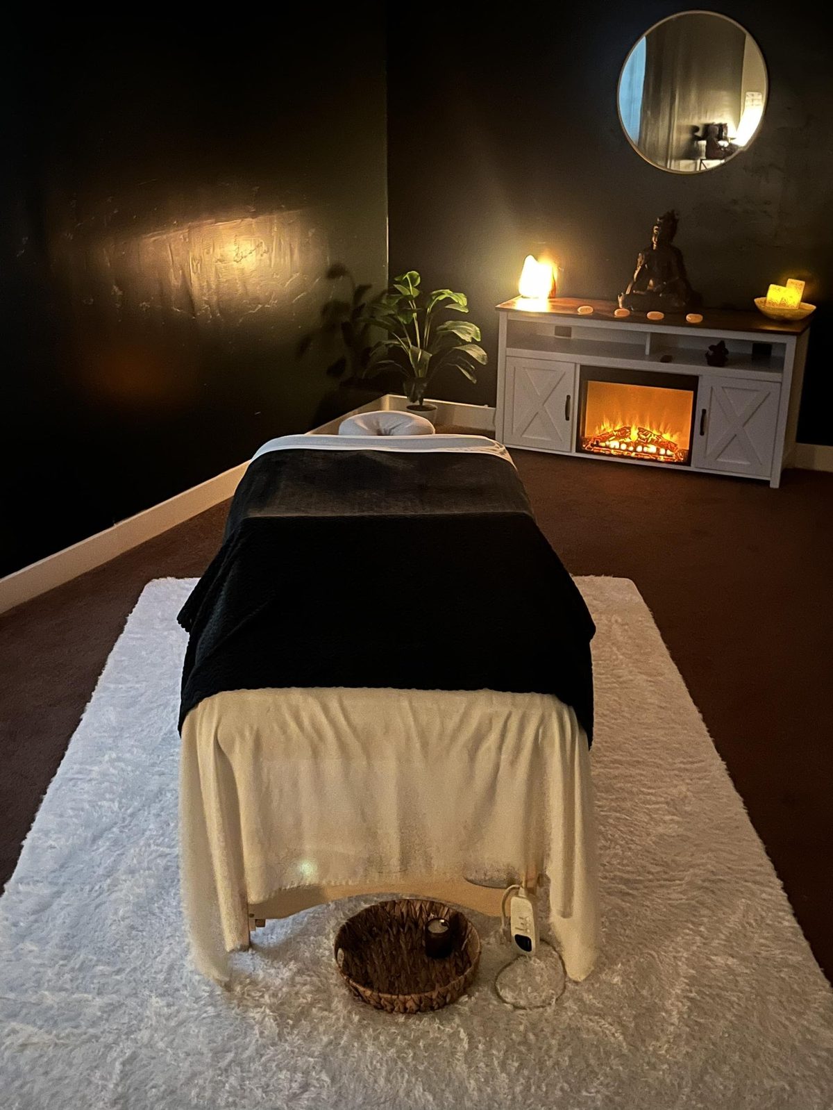 The Euphoria treatment room, lit by a fireplace, candles and salt lamps